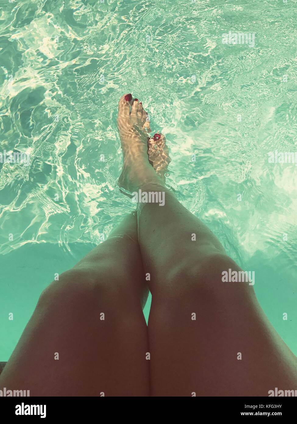 Feet dipping into cold pool Stock Photo - Alamy