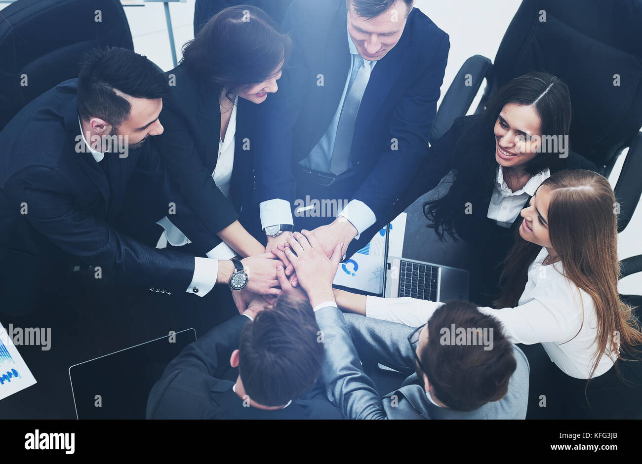 Business team showing unity with their hands together Stock Photo - Alamy