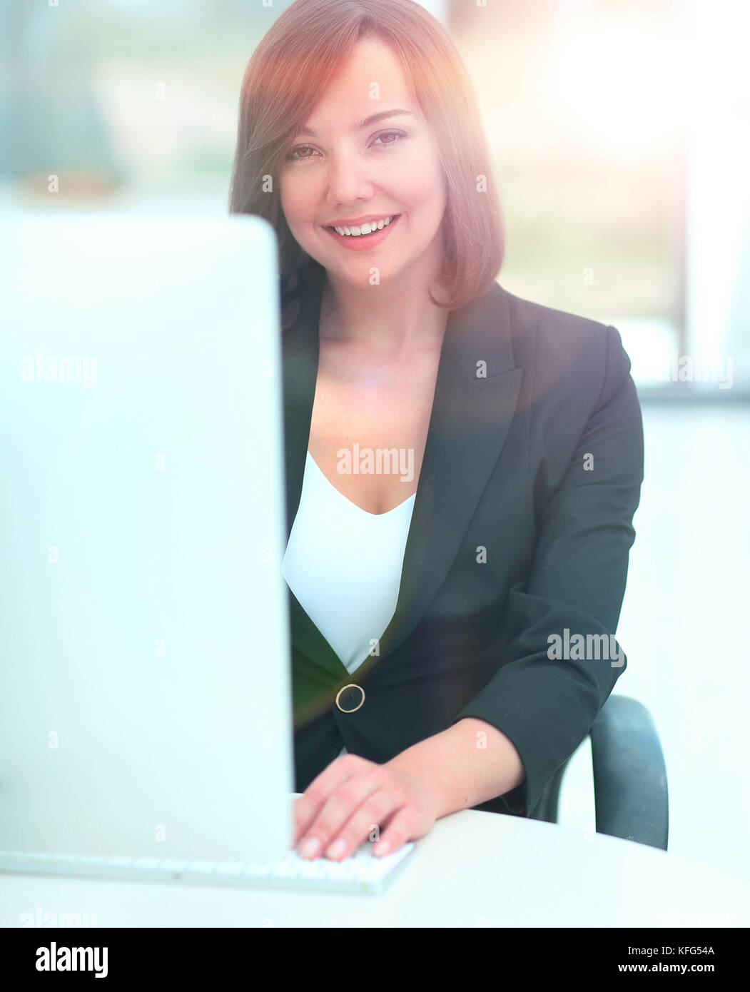 Beautiful business woman working on computer at her office Stock Photo ...
