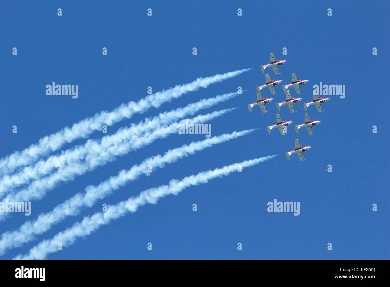 Nine CT-114 Tutor jets of the Canadian Snowbirds pass overhead in a diamond formation. The Snowbirds are part of the 431 Air Demonstration Squadron an Stock Photo