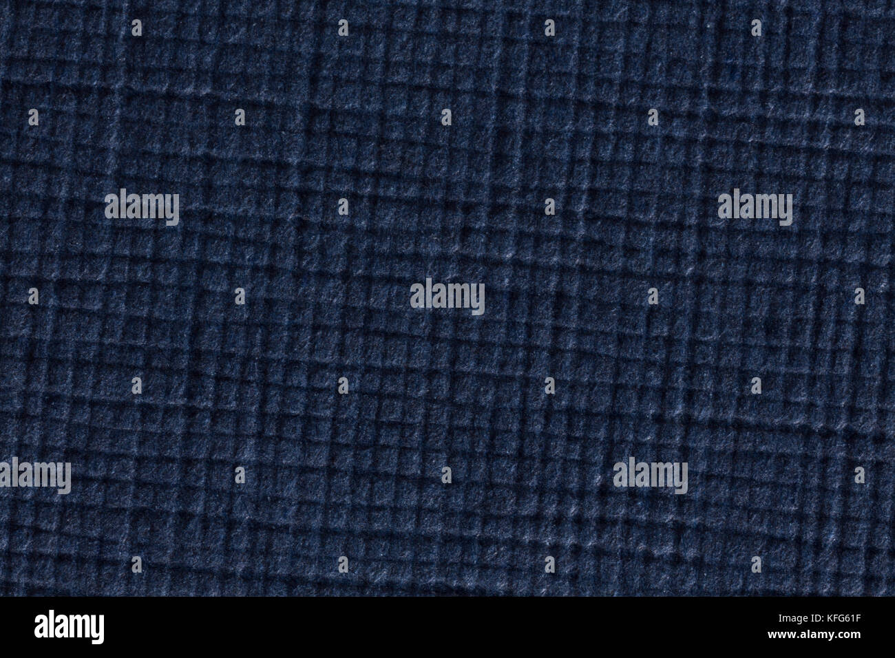 Dark blue checked paper texture background, macro shot. Stock Photo