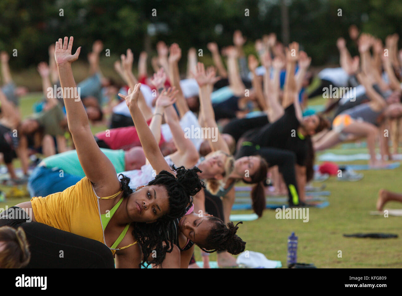 Atlanta, GA, USA July 2, 2017 Dozens of people do the triangle yoga
