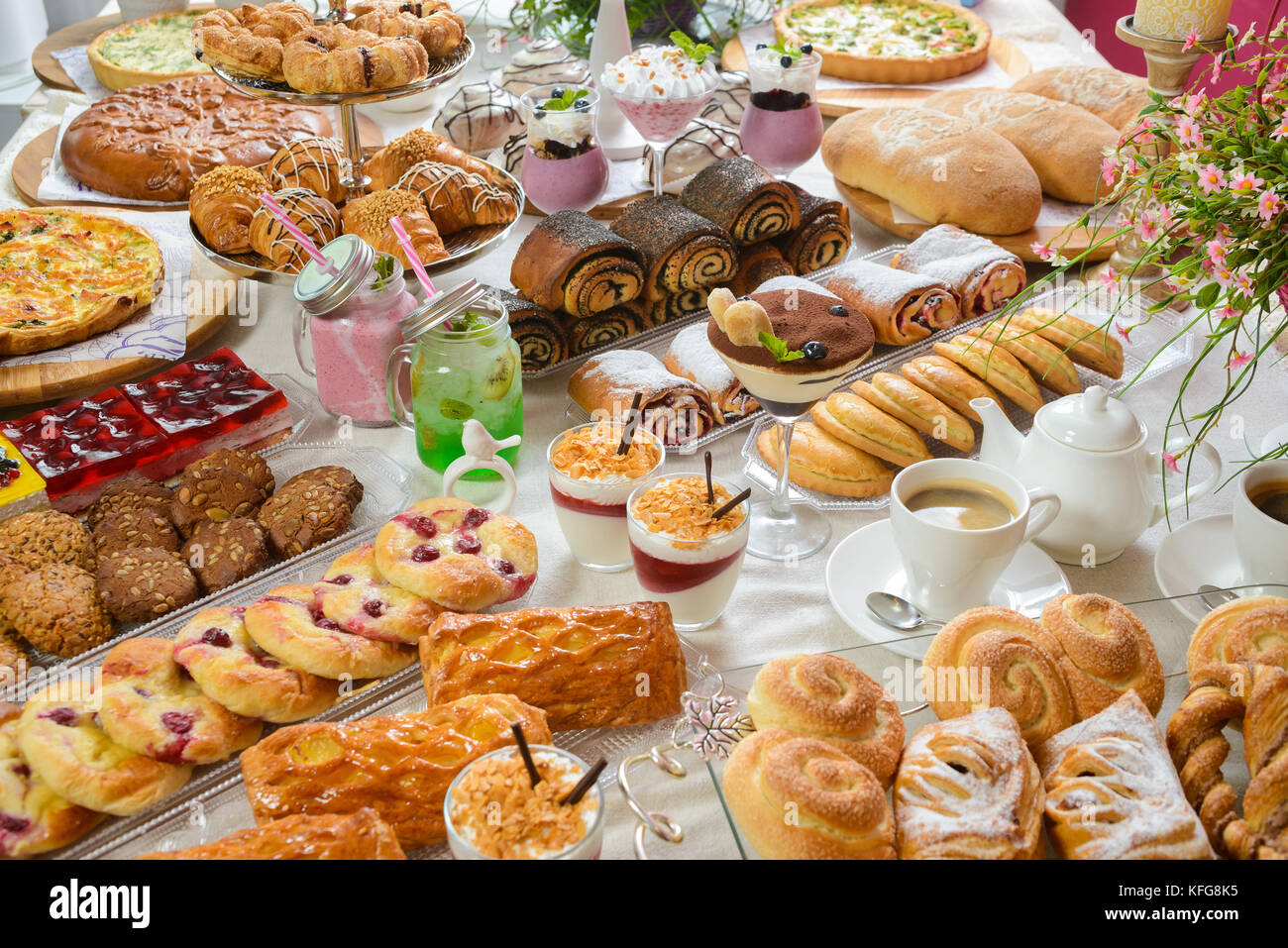 Table full of assorted confectionery sweets and desserts Stock Photo