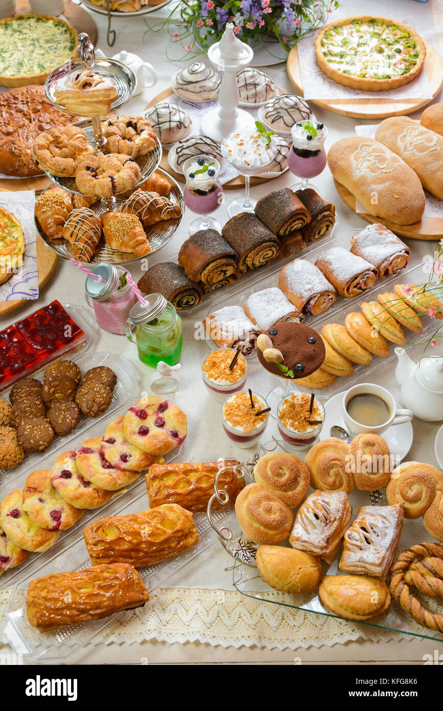 Table full of assorted confectionery sweets and desserts Stock Photo