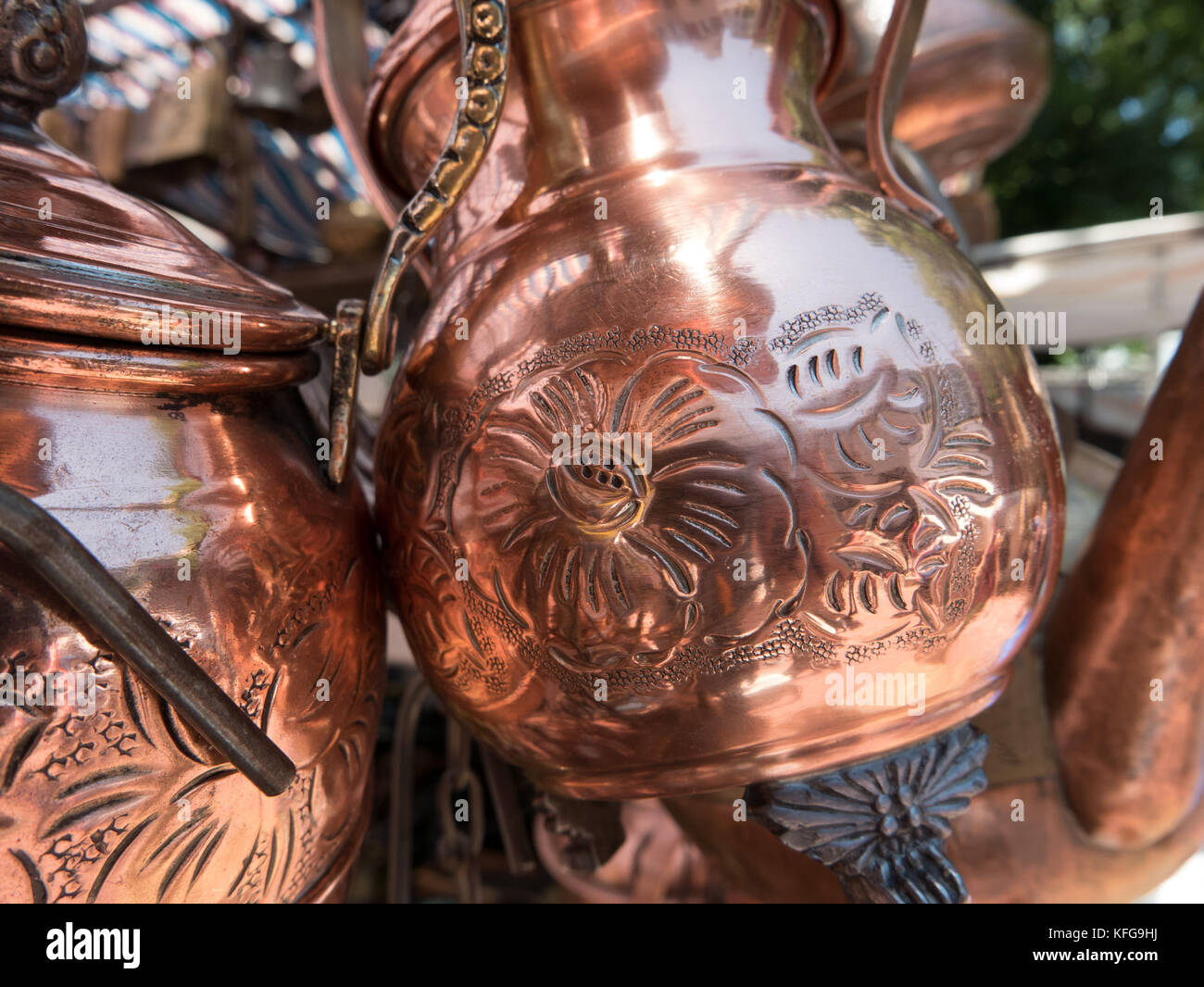 Copper and tin pitchers for sale in Santiago flea market.  Flower pattern on copper jug. Stock Photo