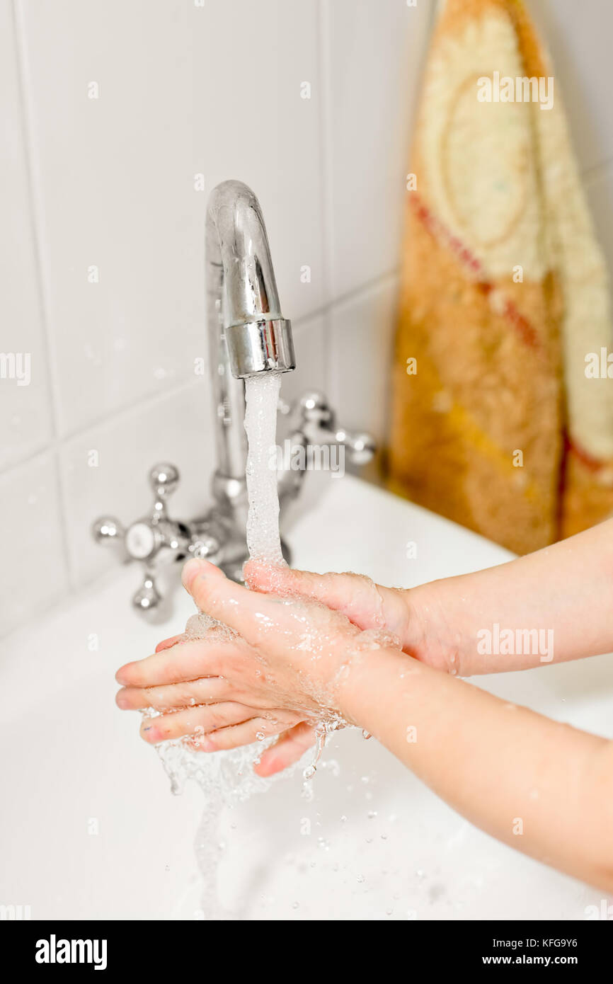Little girl washing her hands in bathroom, shallow focus Stock Photo ...