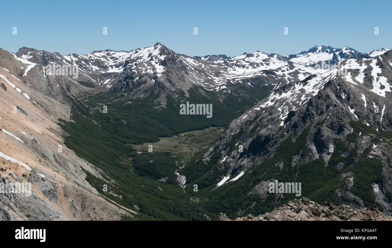 Rugged, awe inspiring mountain peaks of Lago Nahuel national park in Bariloche, Argentina on a crystal clear day with intense blue sky and lakes. Stock Photo