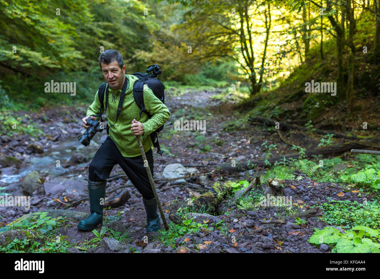 Tourist with camera hiking on a trail by the river Stock Photo - Alamy