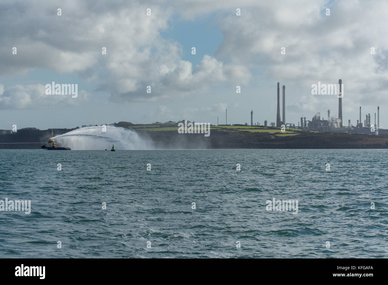 Svitzer Gelliswick outputting impressive jets of water from the fire fighting nozzles in Milford Haven on a calm day Stock Photo
