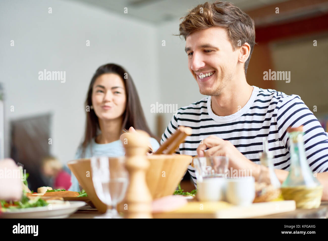 Happy Young Man at Dinner Table Stock Photo