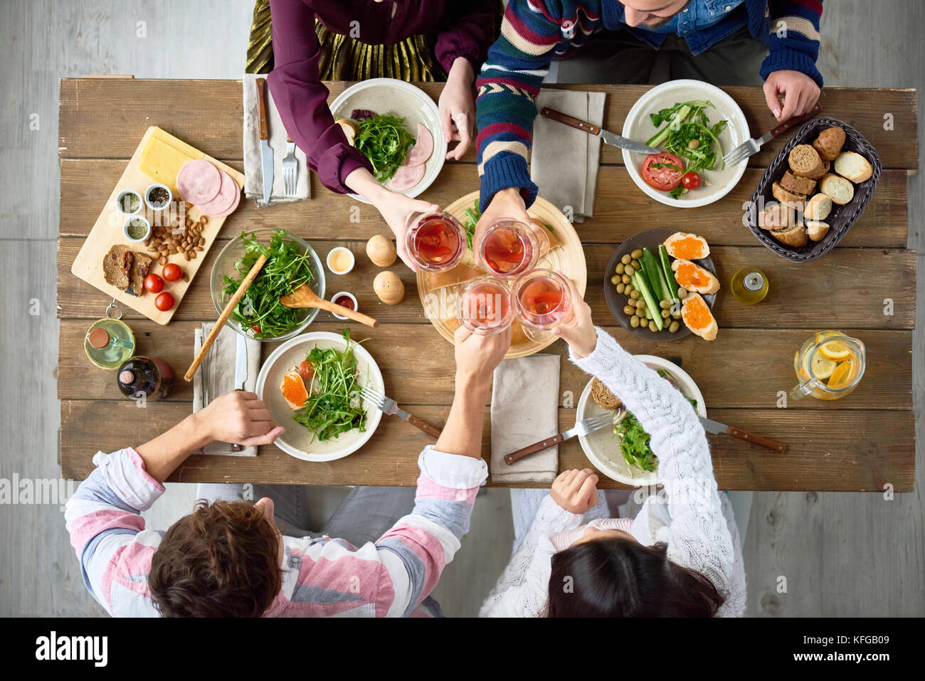 Friends Gathering at Dinner Table Stock Photo