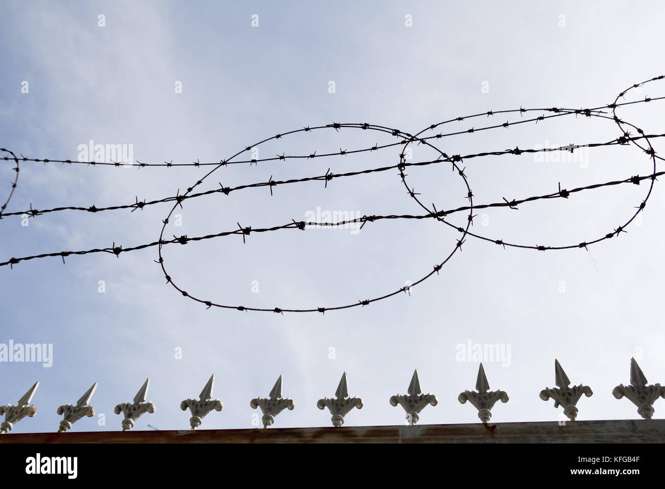 barbed wire fence silhouette with sky Stock Photo