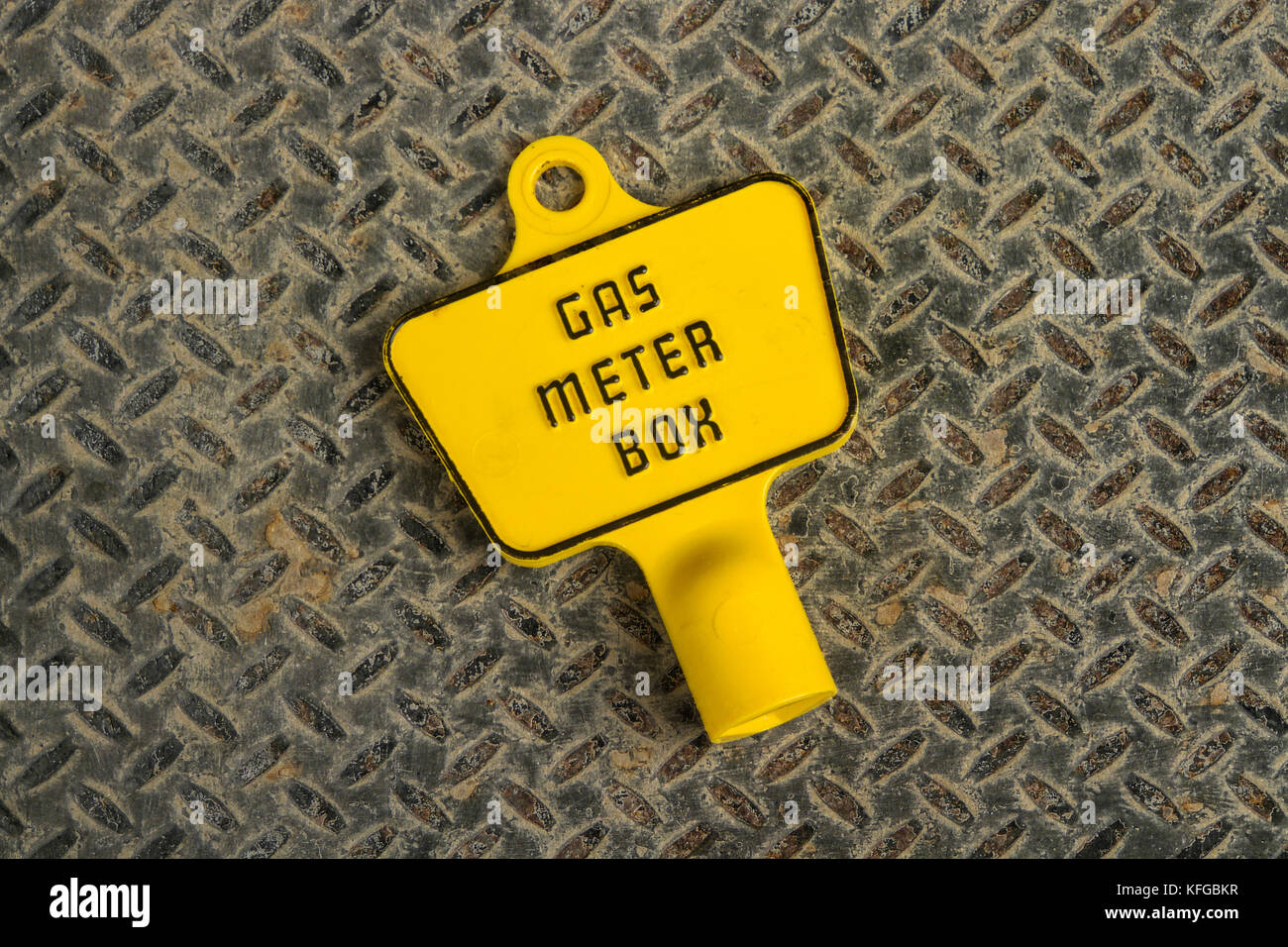 Plastic key for an exterior gas meter box on a metal background Stock Photo
