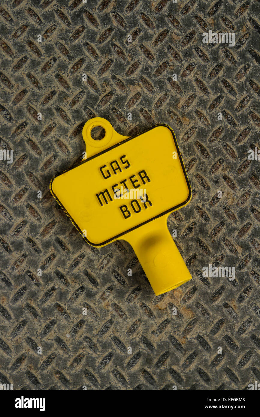 Plastic key for an exterior gas meter box on a metal background Stock Photo