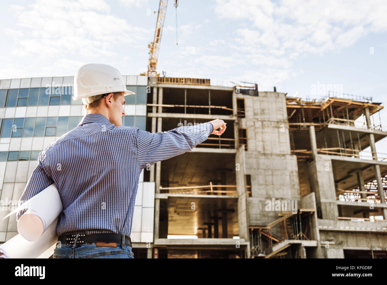 Chief Construction with drawings manages the facility Stock Photo - Alamy