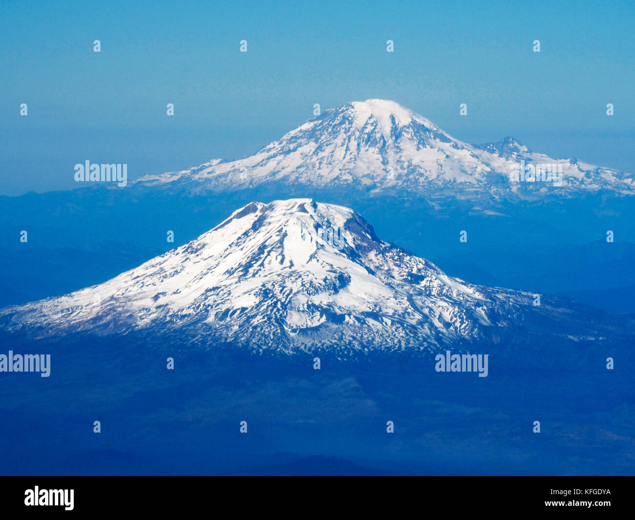 Volcanic peaks of  Mount Adams and Mount Rainier (rear) in Cascade mountain range in state of Washington, USA. Stock Photo
