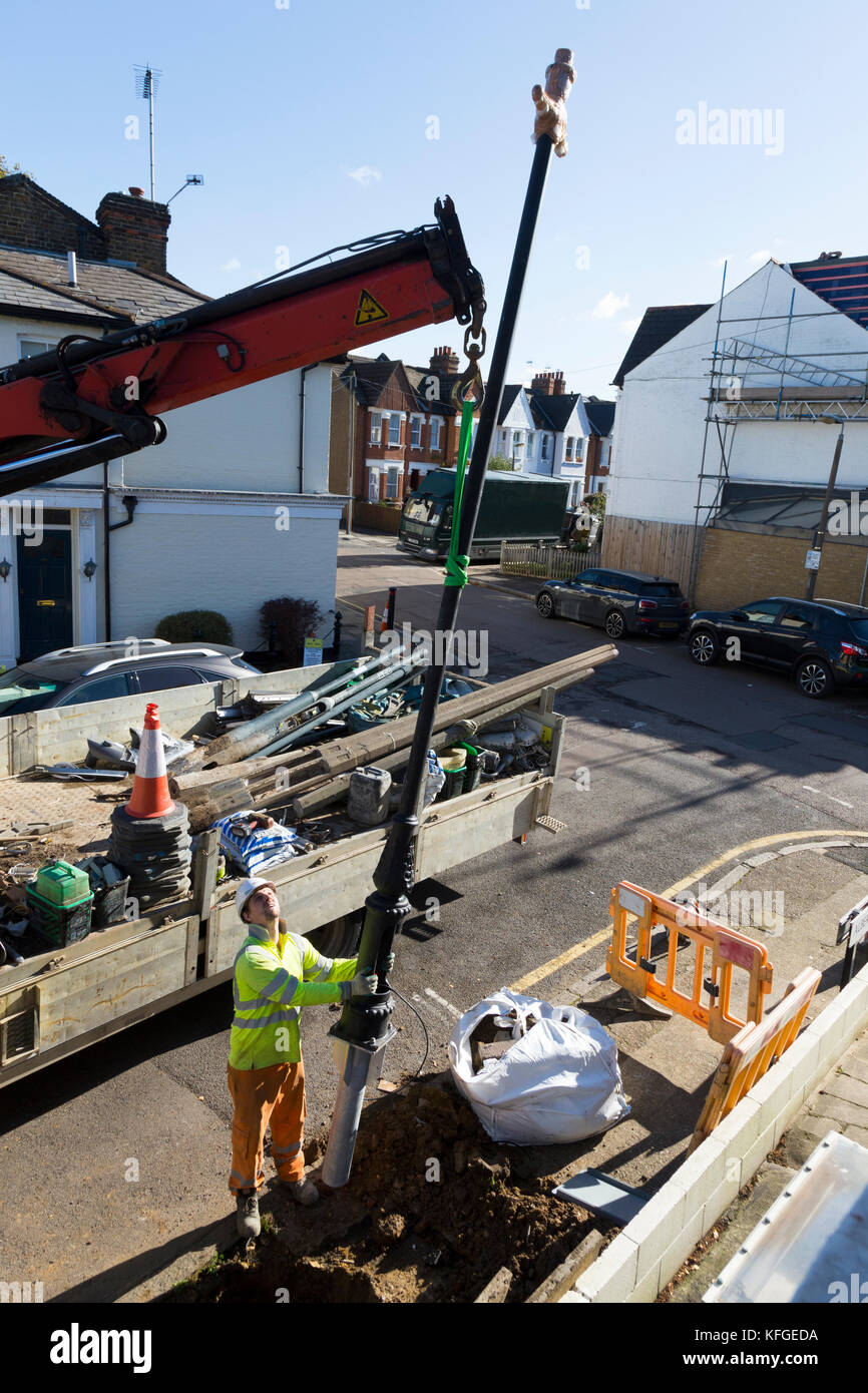 Team of lighting contractors fitting a Heritage street lamp / street