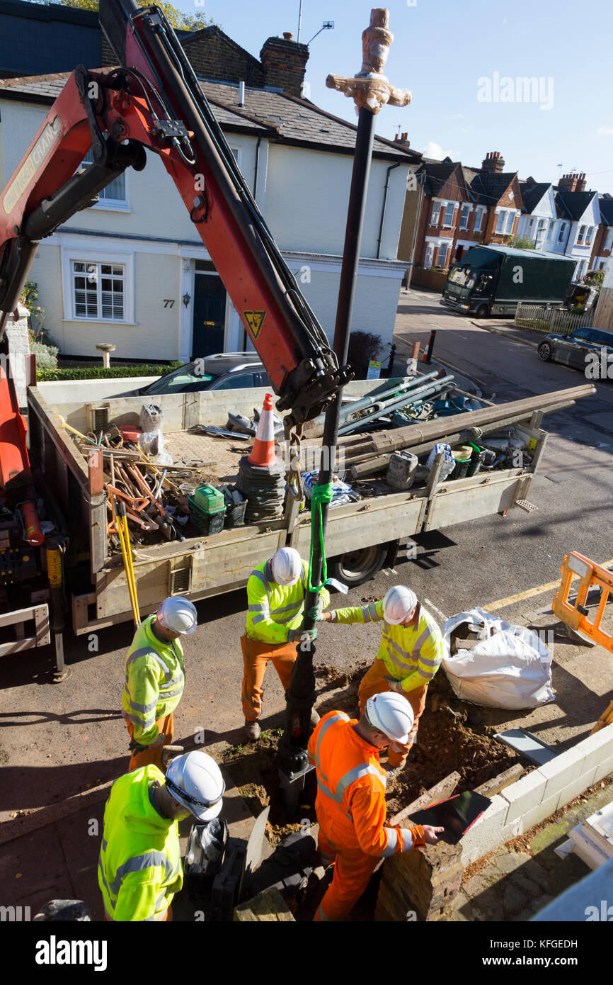 Team of lighting contractors fitting a Heritage street lamp / street