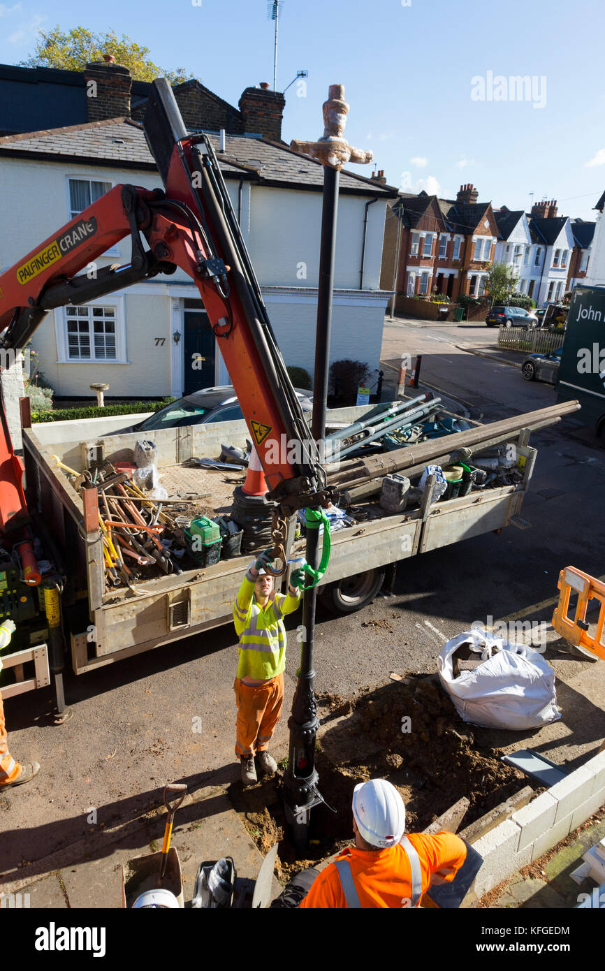 Team of lighting contractors fitting a Heritage street lamp / street