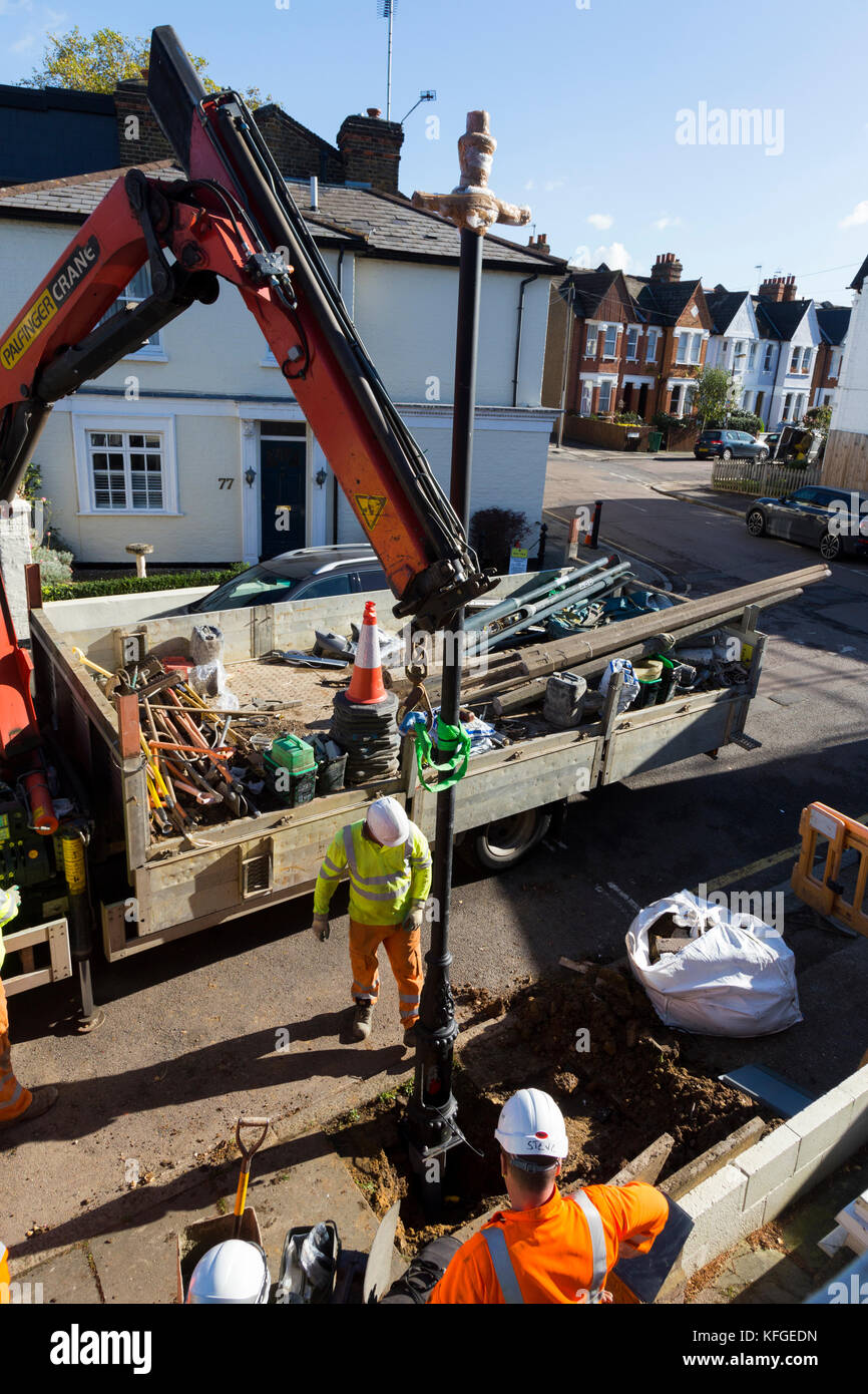 Team of lighting contractors fitting a Heritage street lamp / street
