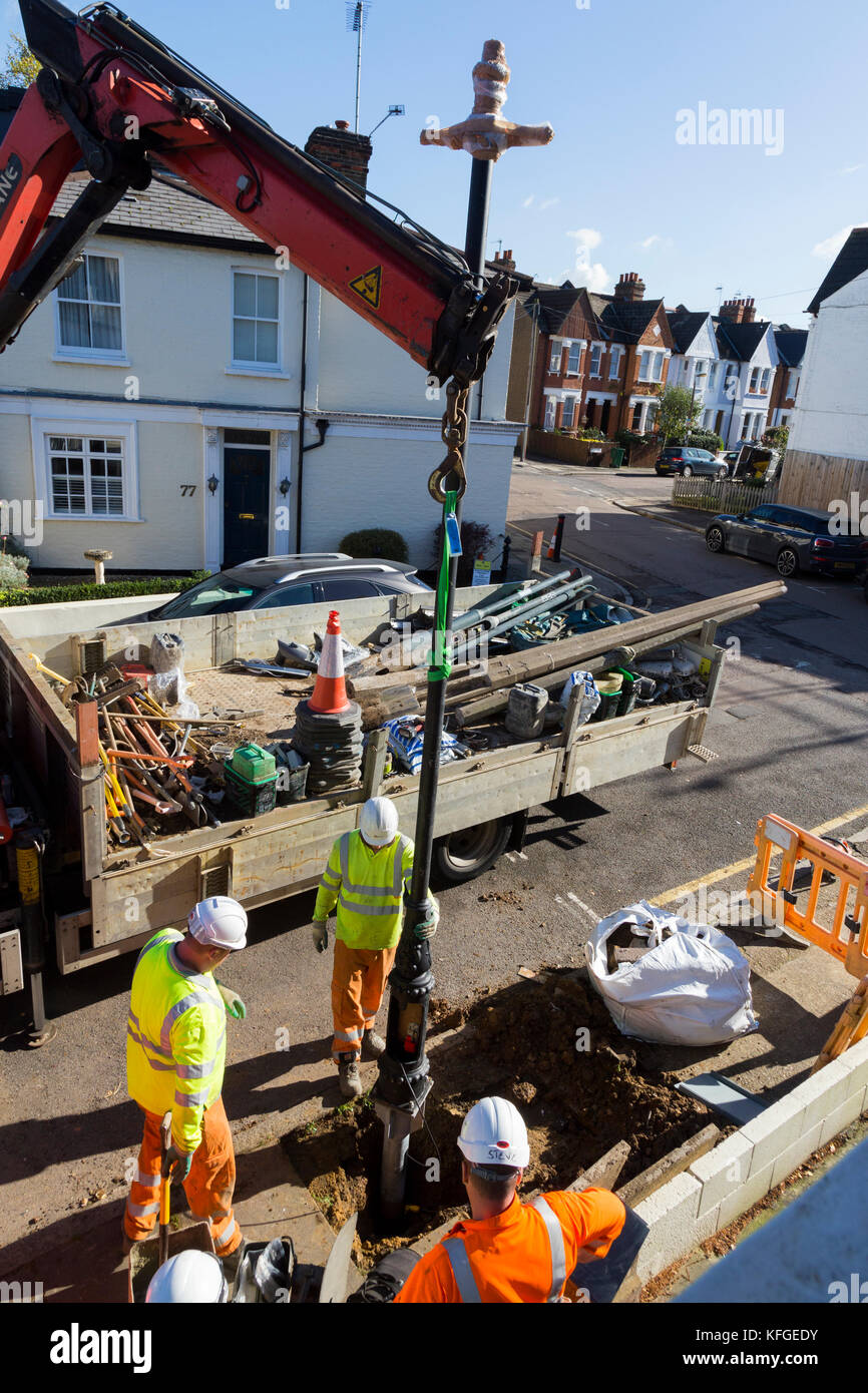 Team of lighting contractors fitting a Heritage street lamp / street