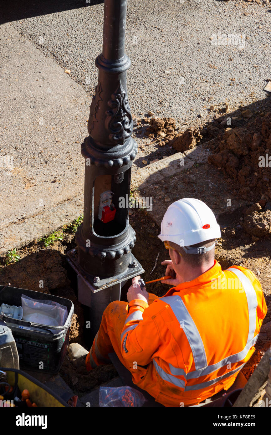 Team of lighting contractors fitting a Heritage street lamp / street