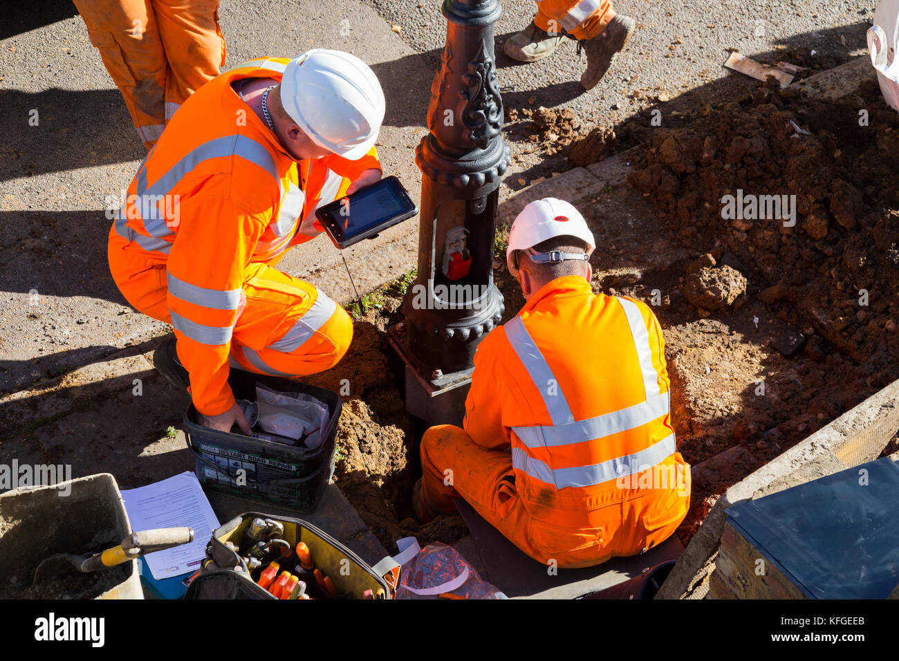 Team of lighting contractors fitting a Heritage street lamp / street