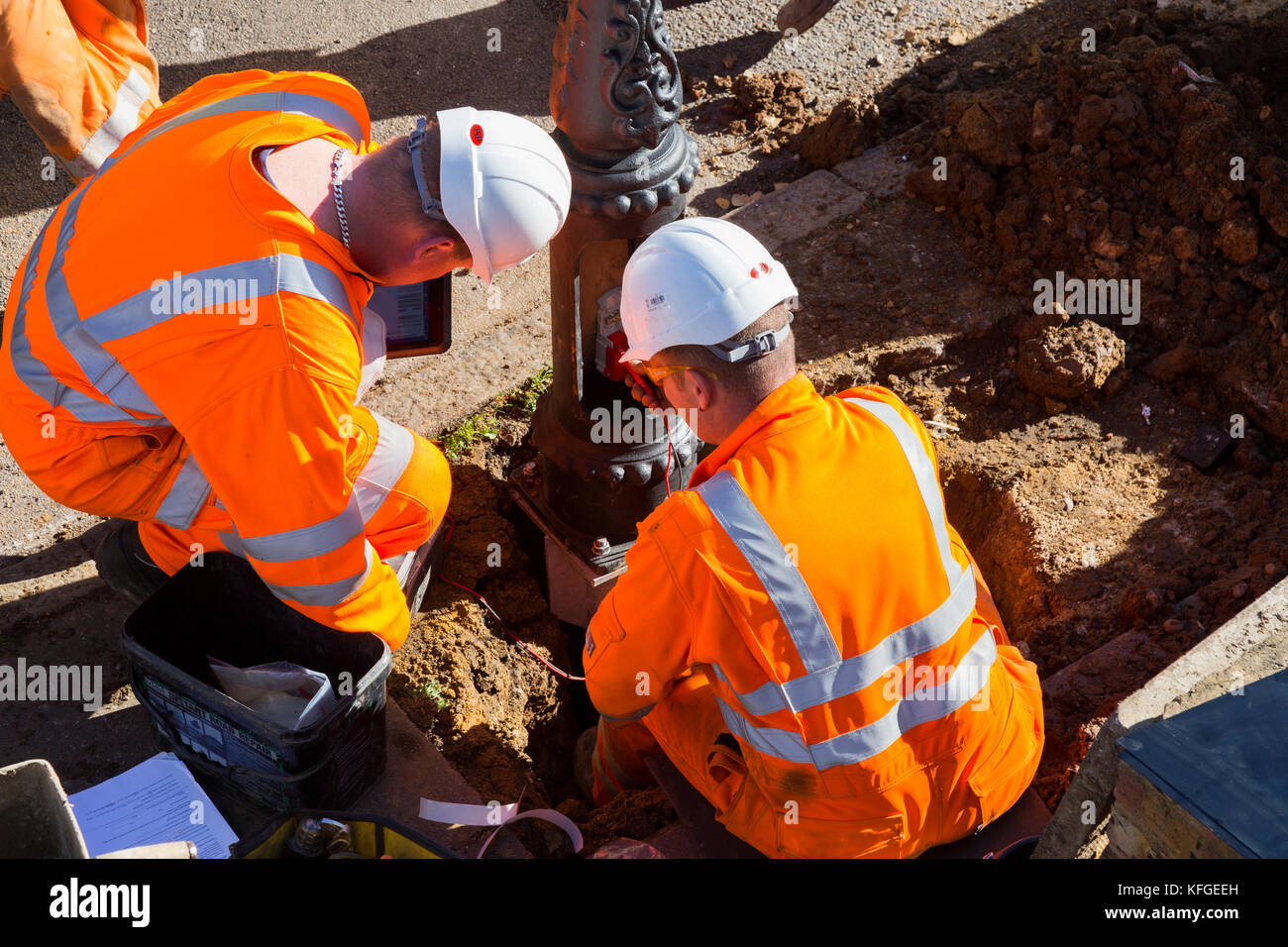 Team of lighting contractors fitting a Heritage street lamp / street