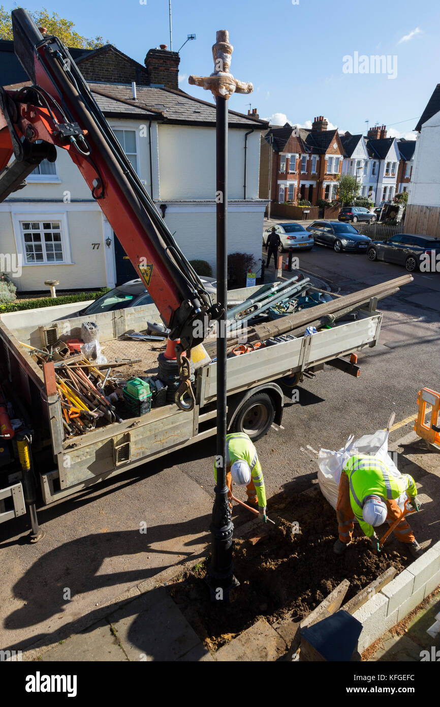 Team of lighting contractors fitting a Heritage street lamp / street
