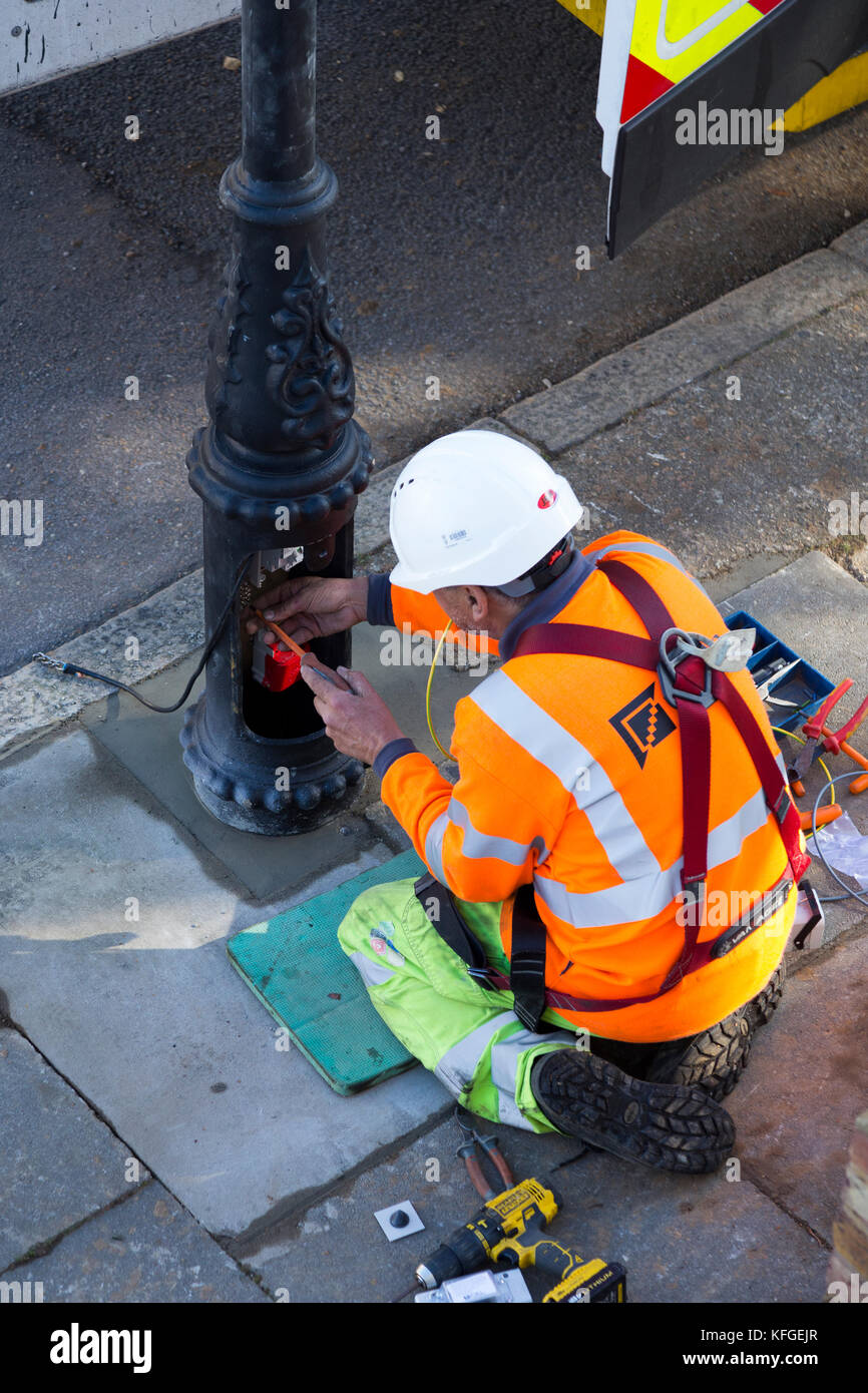 Team of lighting contractors fitting a Heritage street lamp / street