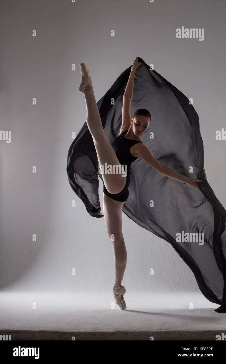 A ballerina dancing with a black cloth in black tights Stock Photo Alamy