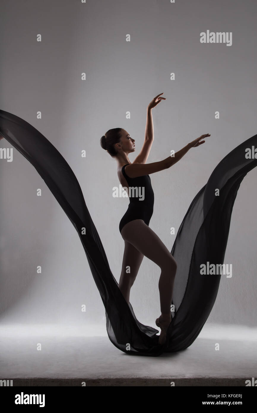 Feminine with arms raised ballerina dancing on black fabric in b Stock  Photo - Alamy