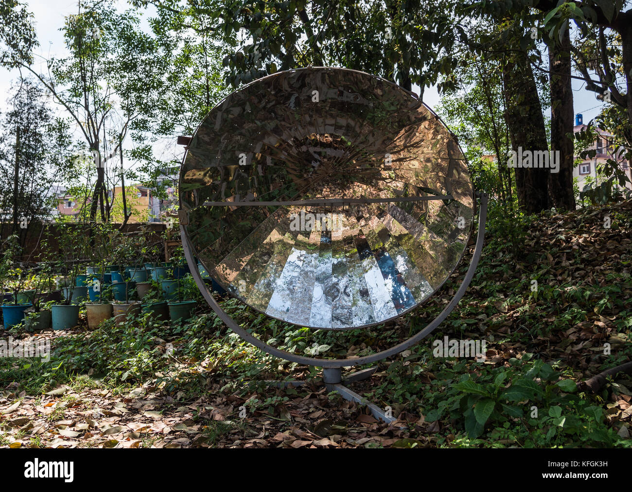 A polished Parabolic mirror gathering solar energy for cooking in developing country. Antananarivo, Madagascar. Stock Photo