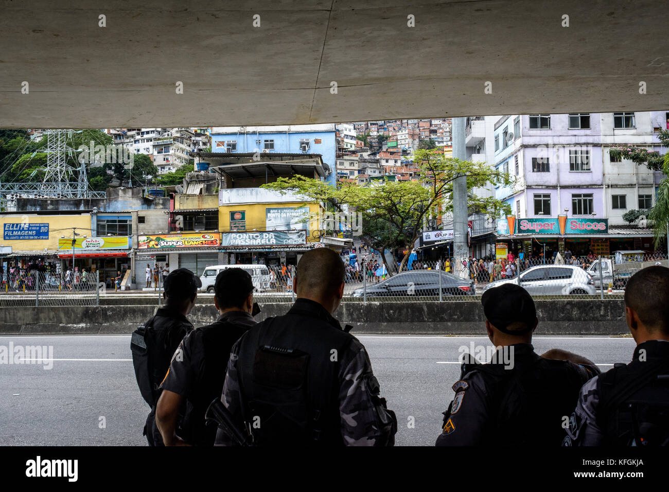 Rio De Janeiro, Brazil. 28th Oct, 2017. Members of the military police look on at the entrance of Rocinha during protests against police violence this Saturday, Oct. 28th, in Rio De Janeiro. There has been an uptick in conflicts in the favela since the police presence was increased following gang violence. Credit: C.H. Gardiner/Pacific Press/Alamy Live News Stock Photo