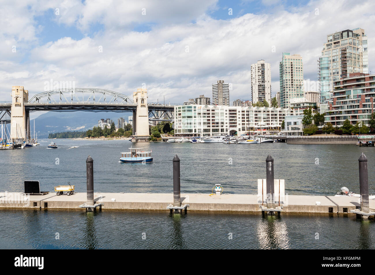 Boat ferries and yachts in False Creek Harbor with Burrard Bridge and ...