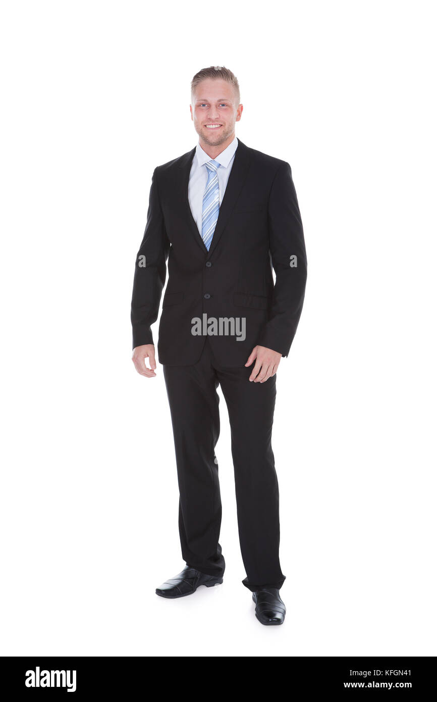 Friendly confident stylish young businessman standing smiling at the ...