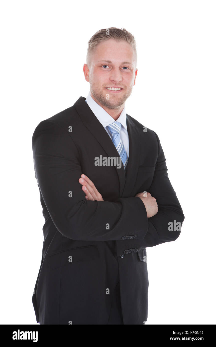Friendly confident stylish young businessman standing smiling at the camera  full length isolated on white Stock Photo