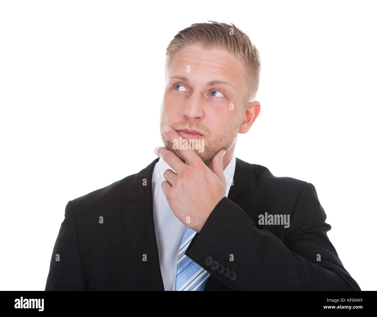 Businessman standing deep in thought with his hand to his chin looking up into the air with a look of contemplation isolated on white with copyspace Stock Photo