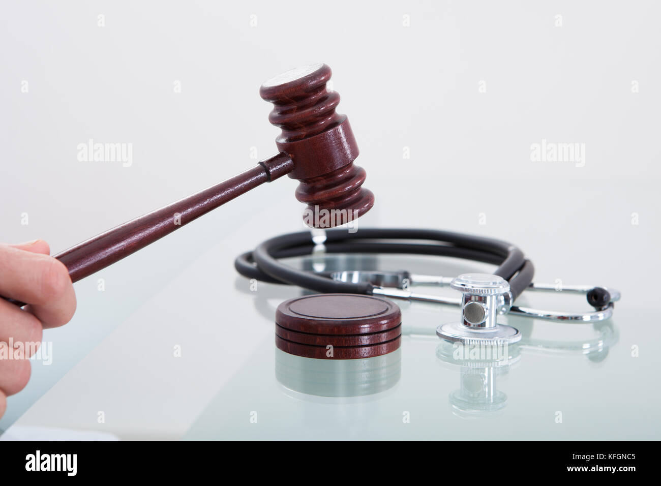 Judges gavel and a stethoscope in a conceptual image of a judgment in a medical malpractice claim Stock Photo