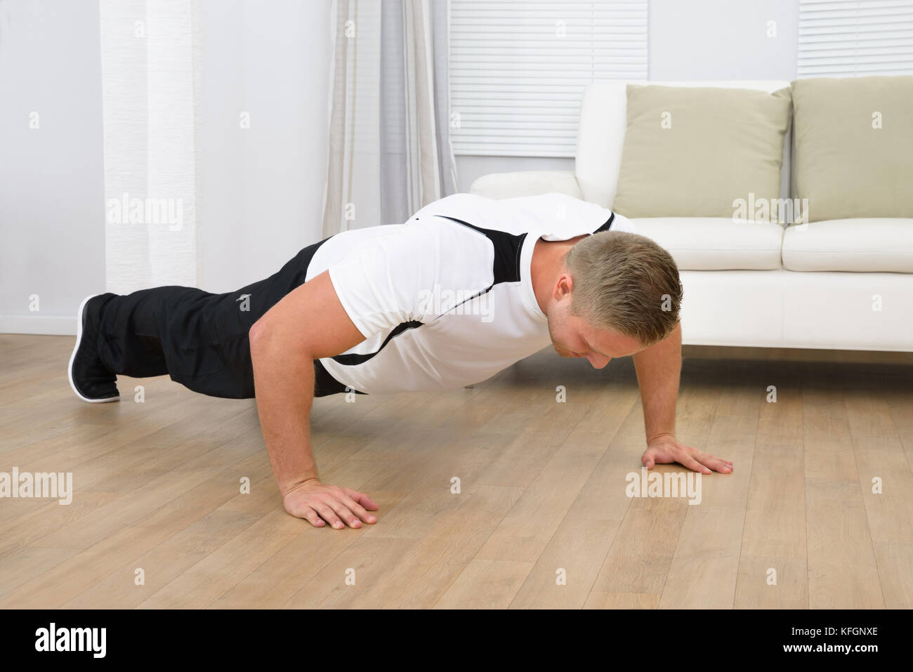 Man Doing Pushup Fitness Exercise At Home Stock Photo