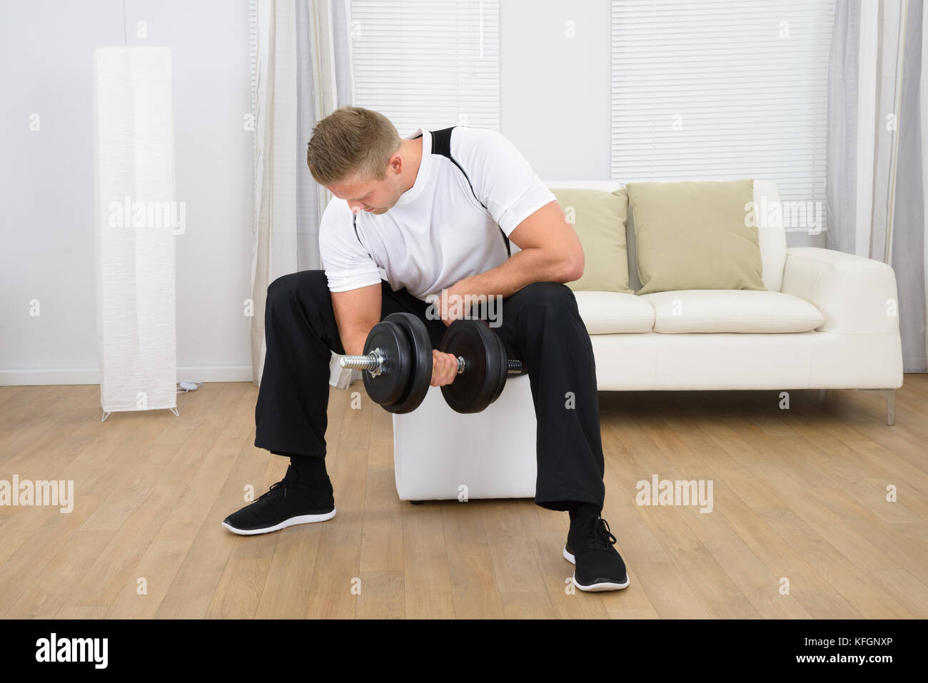 Healthy Sporty Young Man Lifting Weights At Home Stock Photo Alamy