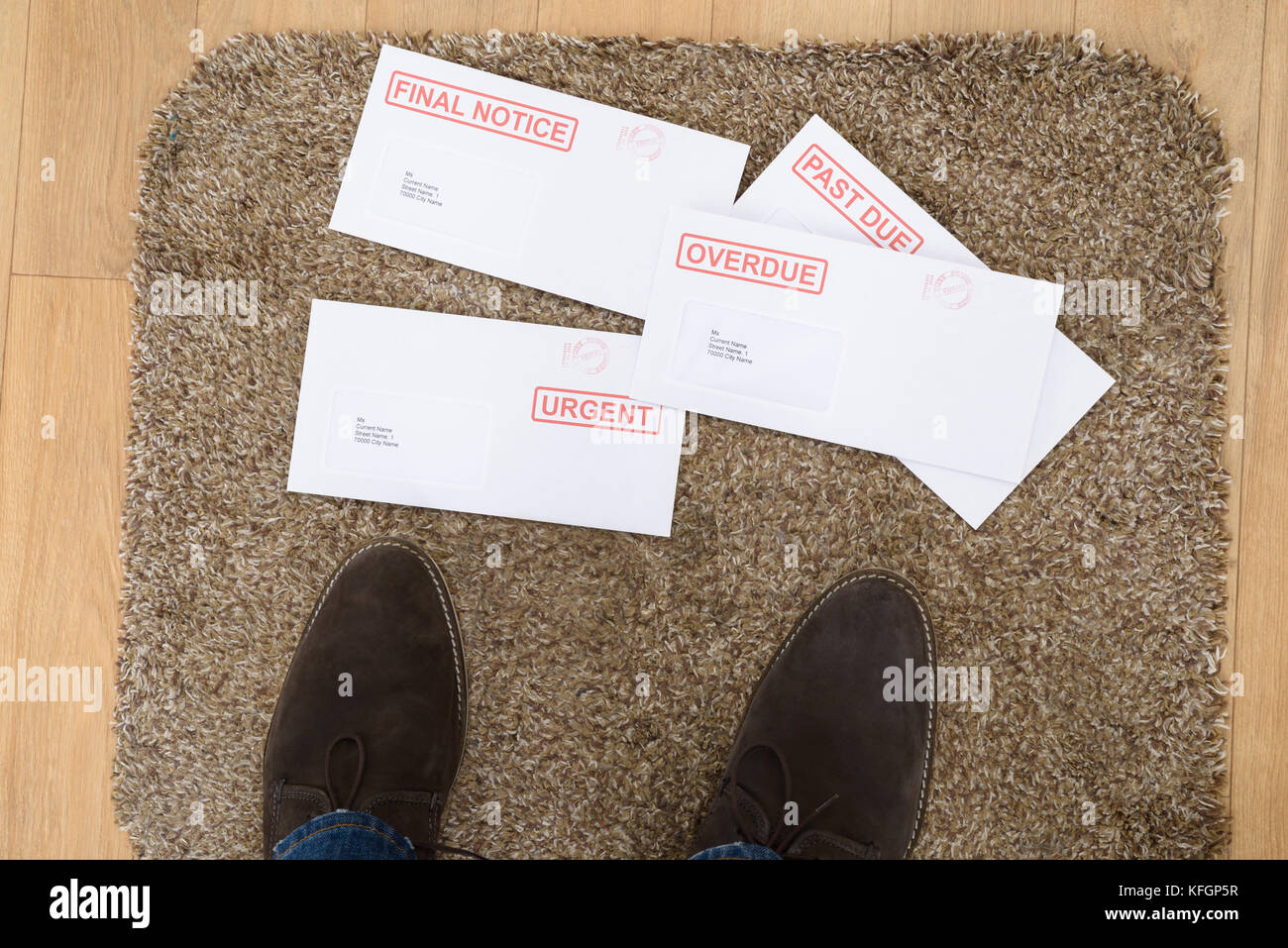 Close-up Of Person's Feet And Important Letters On Doormat Stock Photo
