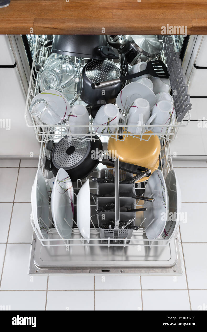Photo Of Utensils Arranged In Dishwasher In Kitchen Stock Photo