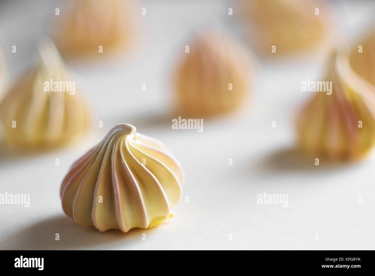 Many yellow Meringue, on white background Stock Photo Alamy