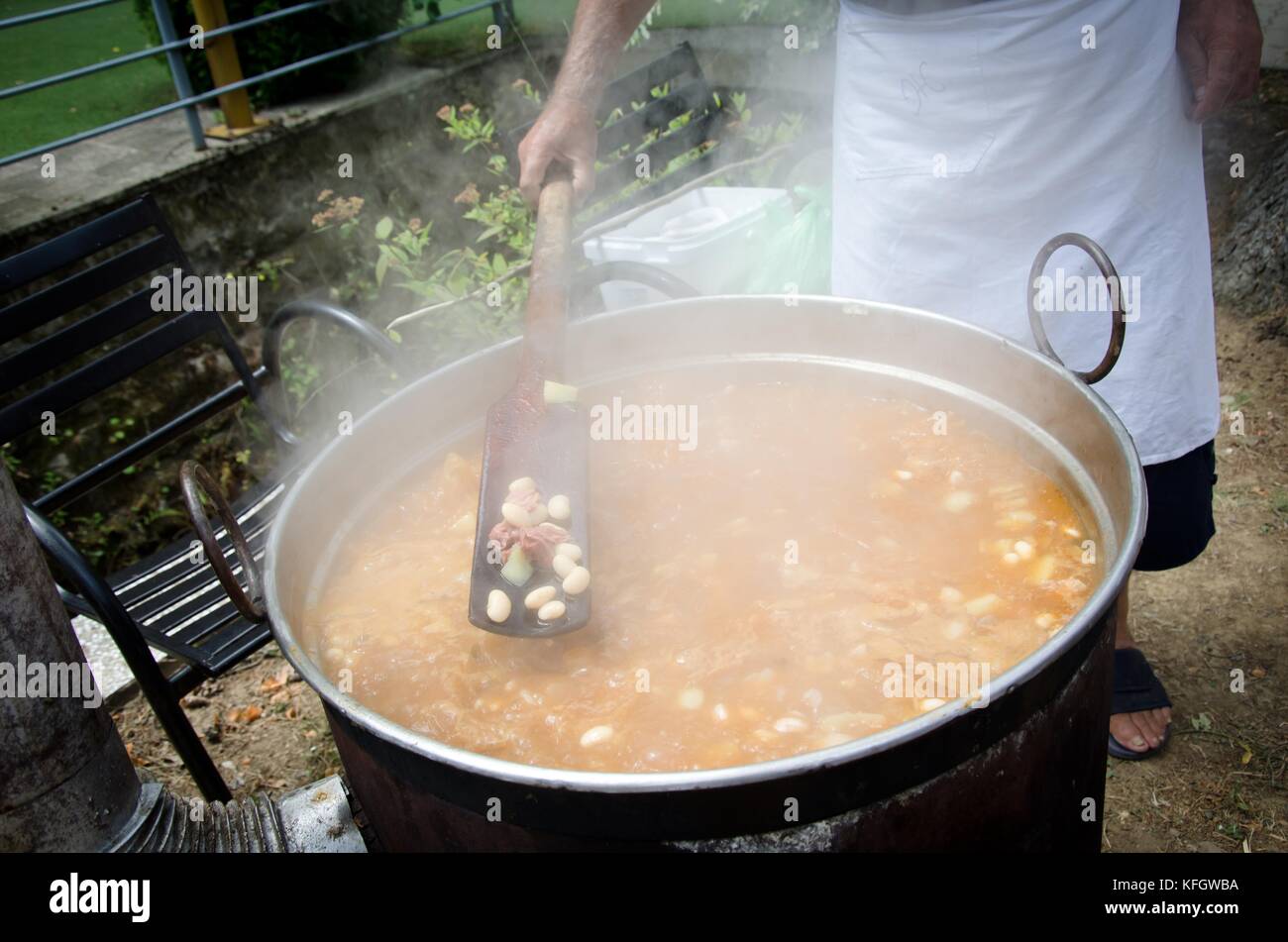 Cooking in a large pot, outside Stock Photo - Alamy