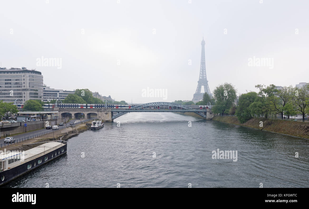 Paris; France-May 05; 2017: View of the Grenelle Bridge. On the embankment are moving cars and pedestrians, along the river-ship Stock Photo