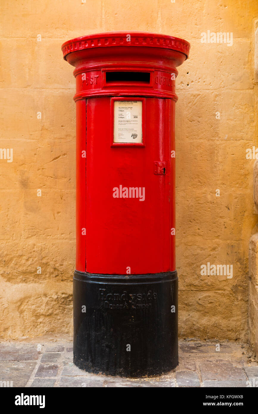 Letter box / letterbox / traditional red GPO / General Post Office pillar box made byAndrew Handyside& Company of Derby situated in Valletta, Malta. Stock Photo