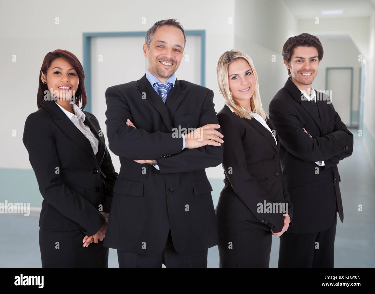 Portrait of confident business team standing together in office Stock ...