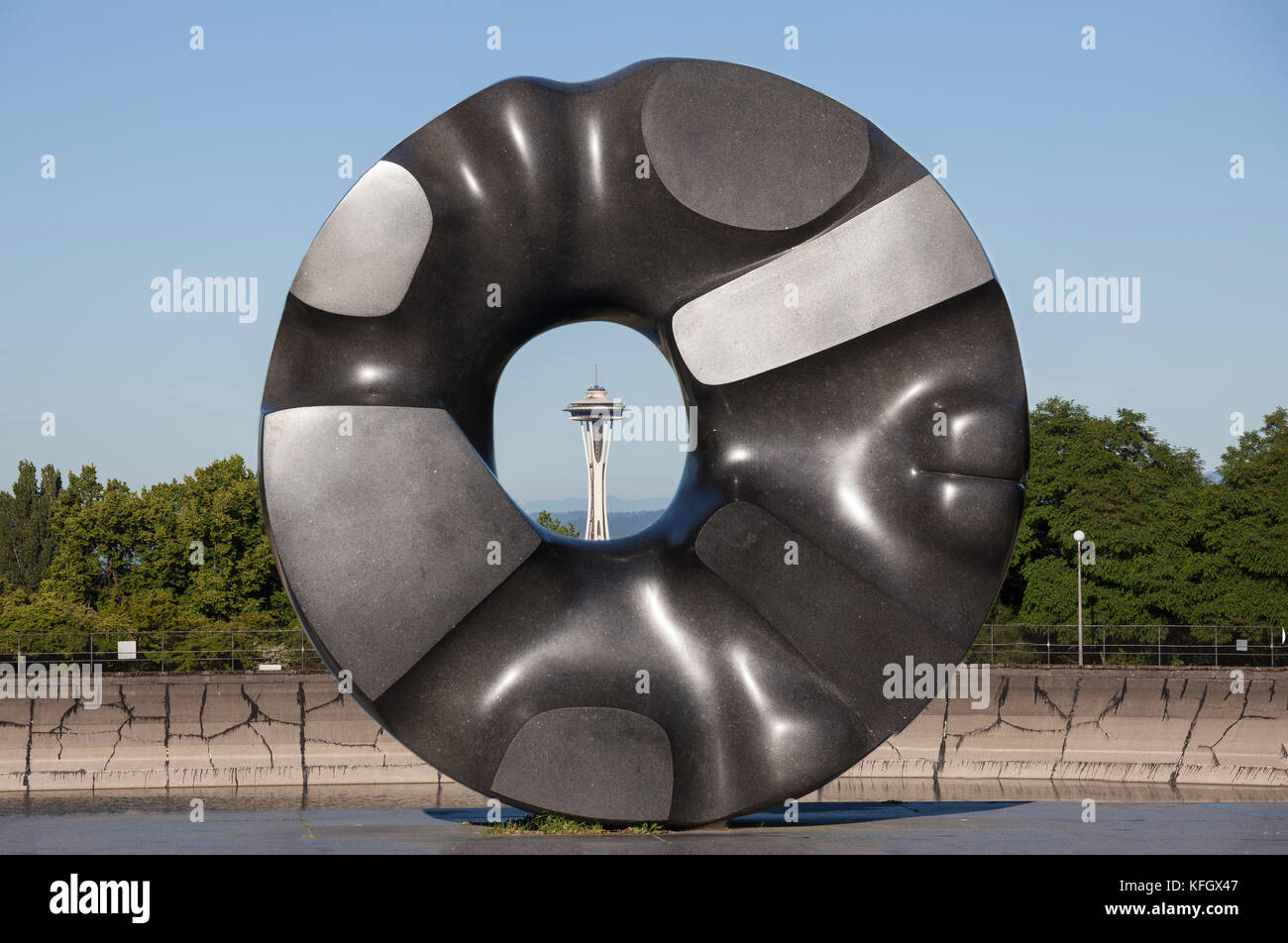 WA14063-00...WASHINGTON - Sculpture Black Hole Sun by Noguchi in Seattles Volunteer Park frames the Space Needle in the distance' Stock Photo