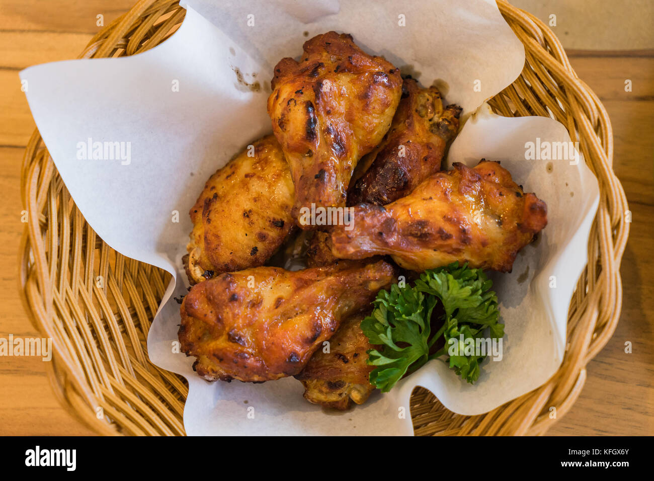Thai fried chickens Hot and Spicy in basket on wooden table Stock Photo